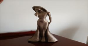 Mini statue of a woman with her head and eyes in one hand